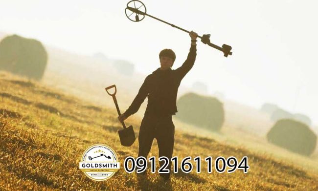 A person holding a metal detector Description automatically generated